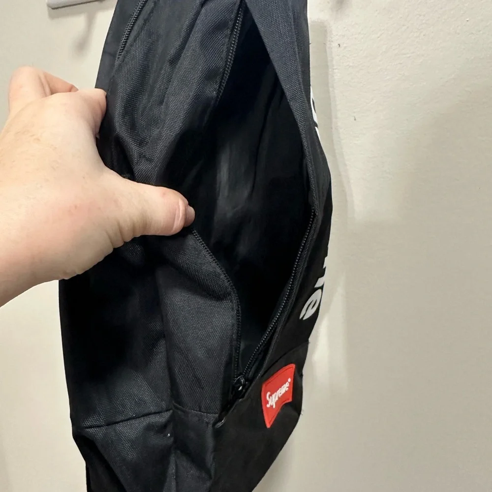 Supreme Black Backpack with White Logo and Red Patch